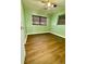 Modest bedroom with hardwood floors and a window bringing in natural light at 253 Walter Ave, Frostproof, FL 33843