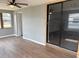 Bedroom with laminate floors, windows, and sliding glass door closet at 253 Walter Ave, Frostproof, FL 33843