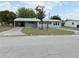 Single-story home with a metal roof, lush lawn and an extended carport at 253 Walter Ave, Frostproof, FL 33843