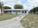 Quaint single-story home featuring a long driveway and mature landscaping at 253 Walter Ave, Frostproof, FL 33843