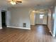Open living area with laminate flooring, view into the kitchen, and a ceiling fan at 253 Walter Ave, Frostproof, FL 33843