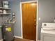 Utility room with water heater, laundry machine, and access door at 253 Walter Ave, Frostproof, FL 33843