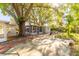 Backyard with shed, screened lanai and stone benches under mature trees at 3027 Maplewood Ave, Lakeland, FL 33803