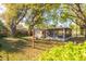 Large backyard with shed and screened lanai under mature trees at 3027 Maplewood Ave, Lakeland, FL 33803