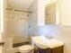 Bathroom featuring tiled shower, a decorative border, a vanity and a toilet at 3027 Maplewood Ave, Lakeland, FL 33803