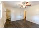 Bedroom featuring wood-look flooring, a ceiling fan, and an attached bathroom at 3027 Maplewood Ave, Lakeland, FL 33803