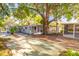 Ranch-style home with mature shade trees, a screened-in lanai and an outdoor lounge space at 3027 Maplewood Ave, Lakeland, FL 33803