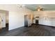 Open-concept kitchen and dining area with modern stainless steel appliances and stylish dark flooring at 3027 Maplewood Ave, Lakeland, FL 33803