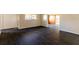 Living room with dark wood-look flooring and neutral walls, providing a versatile space at 3027 Maplewood Ave, Lakeland, FL 33803
