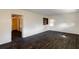 Spacious living room featuring tile flooring, a ceiling fan, and a built-in shelving at 3027 Maplewood Ave, Lakeland, FL 33803