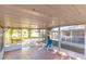 Enclosed patio with tile flooring and a relaxing blue chair at 3027 Maplewood Ave, Lakeland, FL 33803
