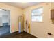 Utility room with water heater, window and dark wood-look floors at 3027 Maplewood Ave, Lakeland, FL 33803