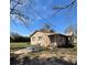View of the back of the house with a patio space and chairs at 334 Main St, Haines City, FL 33844