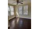 Well-lit bedroom with multiple windows and beautiful hardwood floors at 334 Main St, Haines City, FL 33844