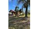 Side view of the property showcasing the home, trees, and lawn at 334 Main St, Haines City, FL 33844