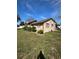 A side view of the house showing green grass, some foundation shrubbery, and the overall yard size at 334 Main St, Haines City, FL 33844