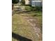 View of the side yard showing an overgrown ditch between neighbors at 334 Main St, Haines City, FL 33844