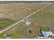 An aerial view of a home on a large lot, with other buildings in the distance at 3608 Garrard Rd, Fort Meade, FL 33841