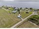 An aerial view of a small neighborhood of houses with large yards, some near a lake at 3608 Garrard Rd, Fort Meade, FL 33841