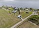 An aerial view of a small neighborhood of houses with large yards, some near a lake at 3608 Garrard Rd, Fort Meade, FL 33841