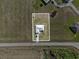 The image depicts a single-story home with a well-maintained yard and convenient road access at 3608 Garrard Rd, Fort Meade, FL 33841