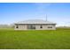 Home back exterior featuring large windows and sliding glass door at 3608 Garrard Rd, Fort Meade, FL 33841