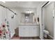 Bathroom featuring double vanity, shower with curtain, and a separate toilet area for added privacy at 3608 Garrard Rd, Fort Meade, FL 33841