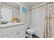 Bright bathroom with a single vanity, toilet, and shower-tub combo with stylish curtain at 3608 Garrard Rd, Fort Meade, FL 33841