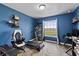 Multi-purpose room with an ergonomic chair, treadmill, and a view from the window at 3608 Garrard Rd, Fort Meade, FL 33841