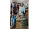 Well-organized walk-in closet with clothing racks, shelves, and plastic storage containers for optimal storage at 3608 Garrard Rd, Fort Meade, FL 33841