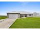 Well-maintained home featuring an attached two car garage, covered entry way, and large front yard at 3608 Garrard Rd, Fort Meade, FL 33841