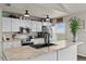 Modern kitchen featuring white cabinetry, stainless steel appliances, and a center island with a black sink at 3608 Garrard Rd, Fort Meade, FL 33841