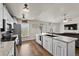 Spacious kitchen flowing into the living room, featuring wood-look flooring and stainless steel appliances at 3608 Garrard Rd, Fort Meade, FL 33841