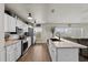 Bright kitchen with stainless steel appliances, white cabinets, a center island and wood-look floors at 3608 Garrard Rd, Fort Meade, FL 33841
