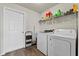 Convenient laundry room with a washer, dryer, utility sink, and storage shelves at 3608 Garrard Rd, Fort Meade, FL 33841