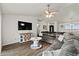 Inviting living room with a sectional couch, wood floors, and entertainment center at 3608 Garrard Rd, Fort Meade, FL 33841
