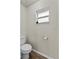Efficient toilet room with a toilet and small frosted glass window providing natural light at 3608 Garrard Rd, Fort Meade, FL 33841