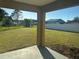 View of the grassy backyard and fence from the covered patio at 379 Renssalaer Ave, Auburndale, FL 33823