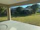 View of the large grassy backyard and fencing from the covered patio at 379 Renssalaer Ave, Auburndale, FL 33823