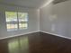 Bright bedroom featuring hardwood floors and a large window that fills the space with natural light at 379 Renssalaer Ave, Auburndale, FL 33823