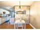 Cozy dining room with modern lighting and an open view to the kitchen at 398 Winter Ridge Blvd # 398, Winter Haven, FL 33881