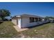 Rear exterior home view showing screened-in porch and brick patio at 398 Winter Ridge Blvd # 398, Winter Haven, FL 33881
