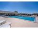 Community pool area featuring ample seating, fencing, and a clubhouse at 398 Winter Ridge Blvd # 398, Winter Haven, FL 33881