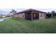 Back exterior shot of property highlighting private screened-in patio and manicured landscaping at 4004 Prima Lago Cir, Lakeland, FL 33810