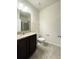 Bathroom features granite countertop, dark wood vanity, tiled flooring, and glass enclosed shower at 4004 Prima Lago Cir, Lakeland, FL 33810