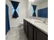 Bathroom featuring a double vanity with granite countertops, dark cabinets, and a separate shower and tub at 4004 Prima Lago Cir, Lakeland, FL 33810