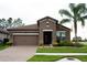 Beautiful single-story home with a tile roof, two-car garage, and well-maintained landscaping at 4004 Prima Lago Cir, Lakeland, FL 33810