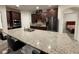 Spacious kitchen featuring a large island with granite countertops, dark cabinets, and stainless steel appliances at 4004 Prima Lago Cir, Lakeland, FL 33810