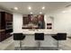 Kitchen island with granite countertops, stainless steel appliances, dark wood cabinets, and barstool seating at 4004 Prima Lago Cir, Lakeland, FL 33810