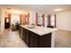 Open concept kitchen with stainless appliances, granite counters, a kitchen island and access to dining area at 4004 Prima Lago Cir, Lakeland, FL 33810